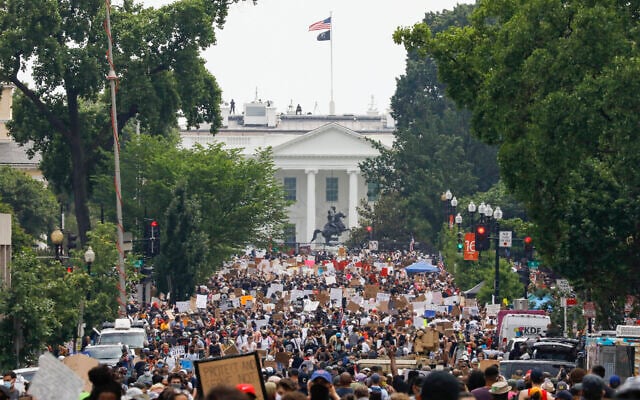Demonstrators protest on June 6, 2020, near the White House in Washington, over the death of George Floyd, a black man who was in police custody in Minneapolis. Floyd died after being restrained by Minneapolis police officers. (AP Photo/Jacquelyn Martin) Demonstrators protest on June 6, 2020, near the White House in Washington, over the death of George Floyd, a black man who was in police custody in Minneapolis. Floyd died after being restrained by Minneapolis police officers. (AP Photo/Jacquelyn Martin)