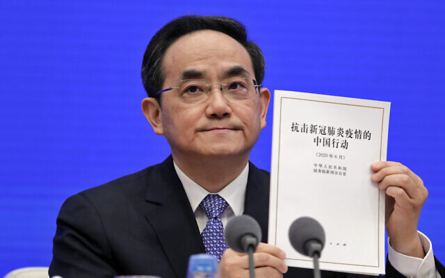 Xu Lin, vice head of the Publicity Department of the Communist Party, shows a copy of the white paper on fighting COVID-19 China in action during a press conference at the State Council Information Office in Beijing, June 7, 2020 (AP Photo/Andy Wong) Xu Lin, vice head of the Publicity Department of the Communist Party, shows a copy of the white paper on fighting COVID-19 China in action during a press conference at the State Council Information Office in Beijing, June 7, 2020 (AP Photo/Andy Wong)
