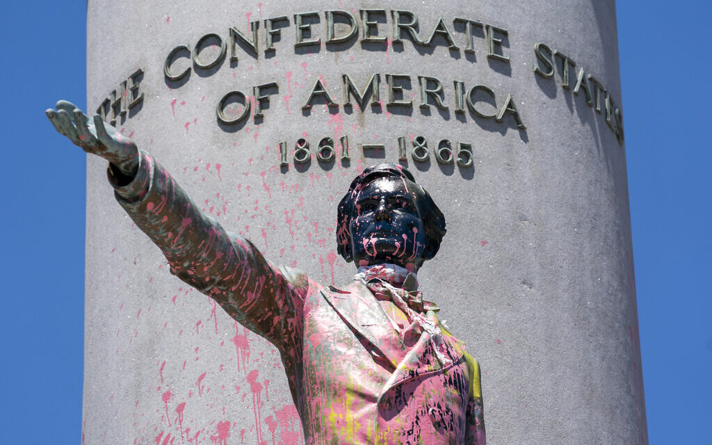 Paint and protest graffiti covers the Jefferson Davis Memorial in Richmond, Va., Sunday, June 7, 2020, following a week of unrest in the U.S. against police brutality and racism in policing. Jefferson Davis was the president of the Confederate States of America during the Civil War. (AP Photo/J. Scott Applewhite)