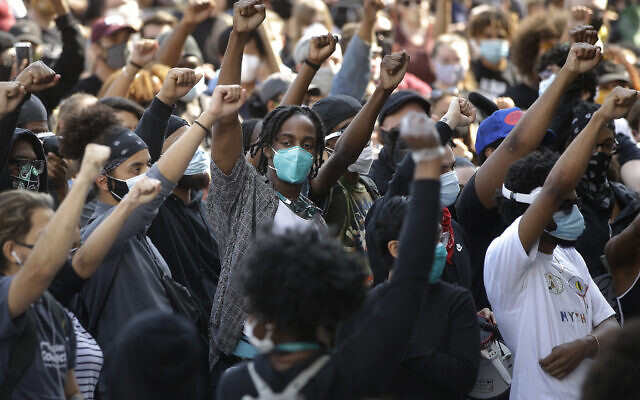 Demonstrators raise their arms during a protest against police brutality, in Boston, June 10, 2020. (Steven Senne/AP) Demonstrators raise their arms during a protest against police brutality, in Boston, June 10, 2020. (Steven Senne/AP)
