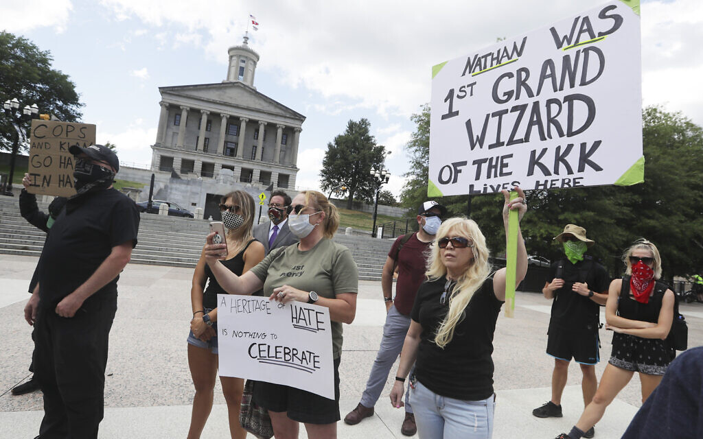 Demonstrators take part in a protest Wednesday, June 10, 2020, in Nashville, Tenn., demanding the removal of a bust of Nathan Bedford Forrest from inside the State Capitol. The bust of the former Confederate general and Ku Klux Klan leader has been the center of controversy for years. (AP Photo/Mark Humphrey)