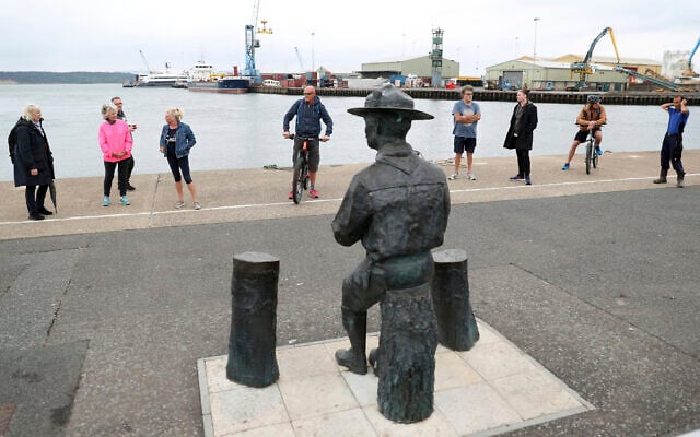 People look at the statue of the founder of the Scout movement Robert Baden-Powell on Poole Quay in Dorset, England ahead of its expected removal to "safe storage" following pressure to remove it over concerns about his alleged actions while in the military and "Nazi sympathies" Thursday June 11, 2020. (Andrew Matthews/PA via AP) People look at the statue of the founder of the Scout movement Robert Baden-Powell on Poole Quay in Dorset, England ahead of its expected removal to "safe storage" following pressure to remove it over concerns about his alleged actions while in the military and "Nazi sympathies" Thursday June 11, 2020. (Andrew Matthews/PA via AP)