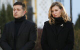 In this file photo taken on Saturday, November 23, 2019, Ukrainian President Volodymyr Zelensky and his wife Olena pay tribute at a monument to victims of the Great Famine in Kyiv, Ukraine. (AP Photo/Efrem Lukatsky)