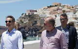Greek Prime Minister Kyriakos Mitsotakis, left, visits the town of Fira in Satorini, June 13, 2020. (Dimitris Papamitsos/ Greek Prime Minister's Office via AP)