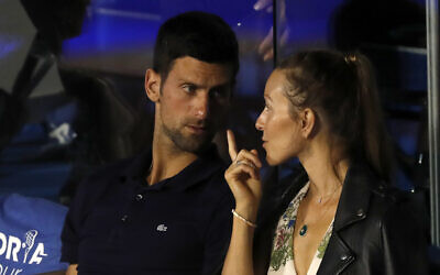 Serbia's Novak Djokovic, left, speaks with his wife Jelena during a final tennis match of the Adria Tour charity tournament, between Austria's Dominic Thiem and Serbia's Filip Krajinovic, in Belgrade, Serbia, June 14, 2020. (AP Photo/Darko Vojinovic)