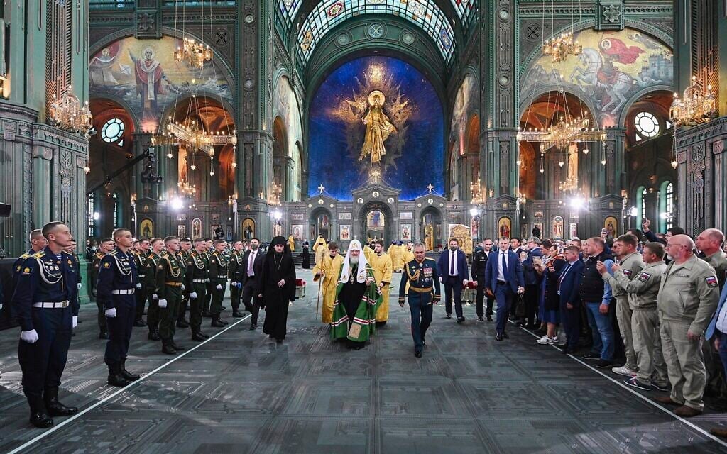 Russian Orthodox Church Patriarch Kirill, center, and Russian Defense Minister Sergei Shoigu, right, arrive to attend the consecrating the country's new Cathedral of Russian Armed Forces in the Patriot Park outside Moscow, Russia Sunday, June 14, 2020. (Oleg Varov, Russian Orthodox Church Press Service via AP)