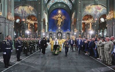 Russian Orthodox Church Patriarch Kirill, center, and Russian Defense Minister Sergei Shoigu, right, arrive to attend the consecrating the country's new Cathedral of Russian Armed Forces in the Patriot Park outside Moscow, Russia Sunday, June 14, 2020. (Oleg Varov, Russian Orthodox Church Press Service via AP)