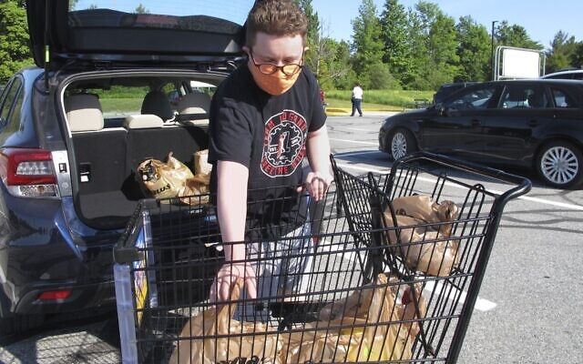 In this June 18, 2020, photo, Steve Picazio loads groceries into his car at Shaw's grocery store in Berlin, Vt. Vermont's ban on single-use plastic bags takes effect July 1, while some other states have postponed theirs amid the coronavirus pandemic. (AP Photo/Lisa Rathke) In this June 18, 2020, photo, Steve Picazio loads groceries into his car at Shaw's grocery store in Berlin, Vt. Vermont's ban on single-use plastic bags takes effect July 1, while some other states have postponed theirs amid the coronavirus pandemic. (AP Photo/Lisa Rathke)