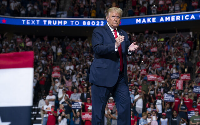 US President Donald Trump arrives on stage to speak at a campaign rally at the BOK Center, Saturday, June 20, 2020, in Tulsa, Okla. (AP Photo/Evan Vucci) US President Donald Trump arrives on stage to speak at a campaign rally at the BOK Center, Saturday, June 20, 2020, in Tulsa, Okla. (AP Photo/Evan Vucci)