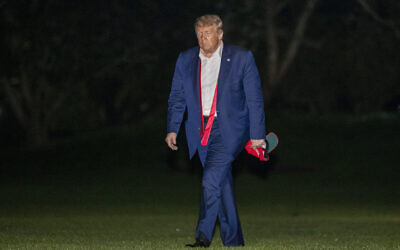 US President Donald Trump walks on the South Lawn of the White House in Washington, early Sunday, June 21, 2020, after stepping off Marine One as he returns from a campaign rally in Tulsa, Okla. (AP Photo/Patrick Semansky)