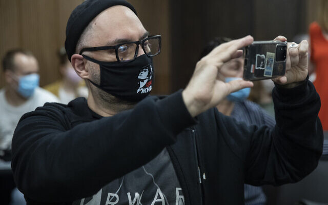 Russian theatre and film director Kirill Serebrennikov wearing a face mask with a portrait of Russian rock singer Viktor Tsoi, takes photos of the media prior to his hearing in a court in Moscow, Russia, June 22, 2020 (AP Photo/Pavel Golovkin) Russian theatre and film director Kirill Serebrennikov wearing a face mask with a portrait of Russian rock singer Viktor Tsoi, takes photos of the media prior to his hearing in a court in Moscow, Russia, June 22, 2020 (AP Photo/Pavel Golovkin)