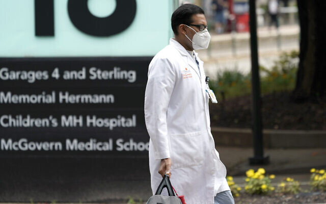 A healthcare professional walks through the Texas Medical Center on June 25, 2020, in Houston. (AP Photo/David J. Phillip) A healthcare professional walks through the Texas Medical Center on June 25, 2020, in Houston. (AP Photo/David J. Phillip)