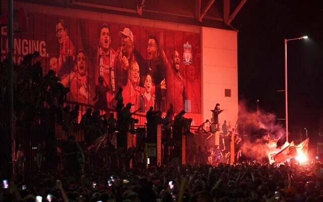 Liverpool supporters celebrate as they gather outside of Anfield Stadium in Liverpool, England, Friday, June 26, 2020 after Liverpool clinched the English Premier League title. Liverpool took the title after Manchester City failed to beat Chelsea on Wednesday evening. (AP photo/Jon Super) Liverpool supporters celebrate as they gather outside of Anfield Stadium in Liverpool, England, Friday, June 26, 2020 after Liverpool clinched the English Premier League title. Liverpool took the title after Manchester City failed to beat Chelsea on Wednesday evening. (AP photo/Jon Super)