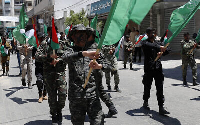 Hamas supporters march on the main road of Khan Younis City, Gaza Strip, on June 26, 2020. (AP Photo/Adel Hana)