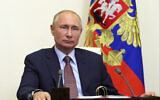 Russian President Vladimir Putin listens during a via video conference at the Novo-Ogaryovo residence outside Moscow, Russia, June 26, 2020. (Mikhail Klimentyev, Sputnik, Kremlin Pool Photo via AP)