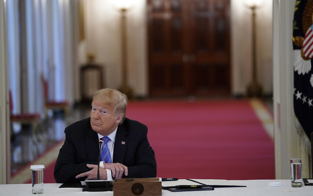 US President Donald Trump listens during a meeting with the American Workforce Policy Advisory Board, in the East Room of the White House, June 26, 2020, in Washington. (Evan Vucci/AP) US President Donald Trump listens during a meeting with the American Workforce Policy Advisory Board, in the East Room of the White House, June 26, 2020, in Washington. (Evan Vucci/AP)