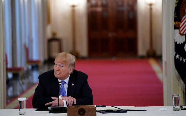 US President Donald Trump listens during a meeting with the American Workforce Policy Advisory Board, in the East Room of the White House, June 26, 2020, in Washington. (Evan Vucci/AP) US President Donald Trump listens during a meeting with the American Workforce Policy Advisory Board, in the East Room of the White House, June 26, 2020, in Washington. (Evan Vucci/AP)