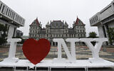 In this June 18, 2019, file photo, a new promotional "I Love NY" sign sits in the Empire State Plaza for installation in front of the New York state Capitol in Albany, New York (AP Photo/Hans Pennink, File)