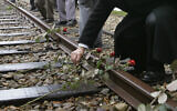 File: Roses are symbolically placed on the railroad tracks at former concentration camp Westerbork, the Netherlands, remembering more than a hundred thousand Jews transported from Westerbork to Nazi death camps during WWII, on May 9, 2015. (Peter Dejong/AP)