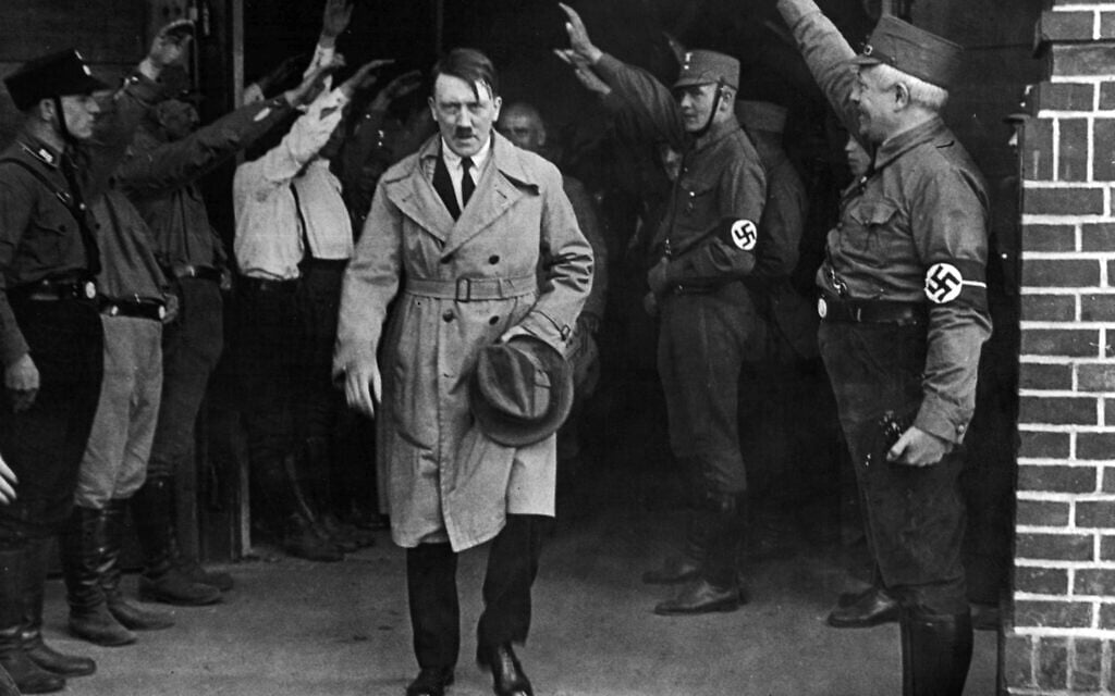 In this Dec. 5, 1931 photo, Adolf Hitler, leader of the National Socialists, is saluted as he leaves the party's Munich headquarters (AP Photo, File) In this Dec. 5, 1931 photo, Adolf Hitler, leader of the National Socialists, is saluted as he leaves the party's Munich headquarters (AP Photo, File)