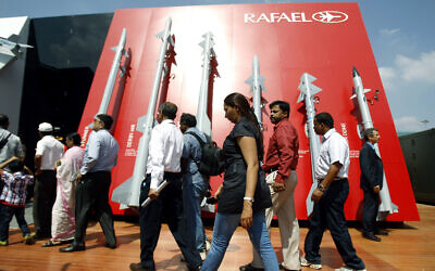 Visitors walk past a display of missiles by Israel's Rafael Advanced Defense Systems Ltd. on the second day of the Aero India 2013 at Yelahanka air base in Bangalore, India, February 7, 2013. (AP Photo/Aijaz Rahi)