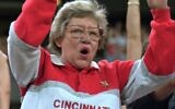 Former Cincinnati Reds owner Marge Schott does the wave during a game at Riverfront Stadium, September 1, 1995, in Cincinnati. (AP Photo/Tom Uhlman)