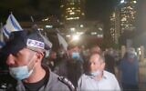 Screen capture from video as journalist and commentator Amnon Abramovich, center, is escorted by police after he was surrounded by a mob at a right-wing protest in Tel Aviv, June 20, 2002. (Twitter)