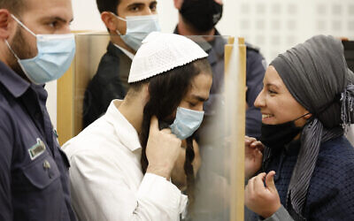 Amiram Ben Uliel (left), convicted of carrying out the Duma terror attack, arrives for a hearing at the Lod District Court on June 9, 2020. (Tomer Appelbaum/Haaretz/Pool)