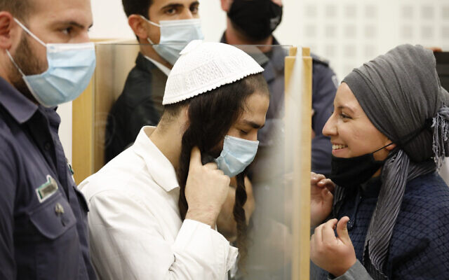 Amiram Ben Uliel (left), convicted of carrying out the Duma terror attack, arrives for a hearing at the Lod District Court on June 9, 2020. (Tomer Appelbaum/Haaretz/Pool) Amiram Ben Uliel (left), convicted of carrying out the Duma terror attack, arrives for a hearing at the Lod District Court on June 9, 2020. (Tomer Appelbaum/Haaretz/Pool)