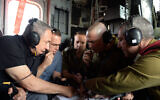 Illustrative: Prime Minister Benjamin Netanyahu (L) looks at a map with military officers as he rides on a helicopter to see a newly built portion of the West Bank security barrier, July 20, 2016. (Haim Zach/GPO/Flash90)