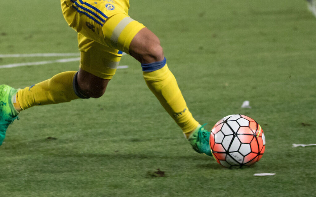 A Maccabi Tel Aviv player kicks a ball during a match (Yonatan Sindel/Flash90) A Maccabi Tel Aviv player kicks a ball during a match (Yonatan Sindel/Flash90)