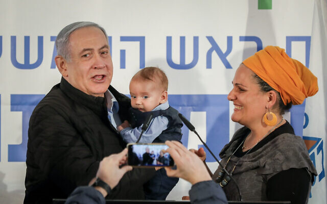Prime Minister Benjamin Netanyahu holds a baby named after him during a tree planting event for the Jewish holiday of Tu Bishvat, in the West Bank settlement of Mevo'ot Yericho on February 10, 2020. (Flash90) Prime Minister Benjamin Netanyahu holds a baby named after him during a tree planting event for the Jewish holiday of Tu Bishvat, in the West Bank settlement of Mevo'ot Yericho on February 10, 2020. (Flash90)