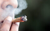 An illustrative photo of a man smoking a joint. (Yossi Zamir/Flash90)