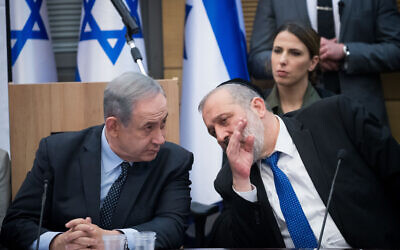 Prime Minister Benjamin Netanyahu, left, with Shas party chairman Interior Minister Aryeh Deri, March 4, 2020. (Yonatan Sindel/Flash90)