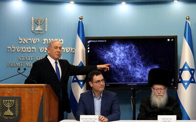 Prime Minister Benjamin Netanyahu, left, then-health minister Yaakov Litzman, right, and Health Ministry Director General Moshe Bar Siman-Tov at a press conference about the coronavirus at the Prime Minister's Office in Jerusalem on March 11, 2020. (Flash90)