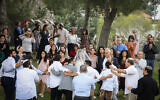 A couple celebrates their wedding at a public park in Efrat, March 15, 2020. (Gershon Elinson/Flash90)