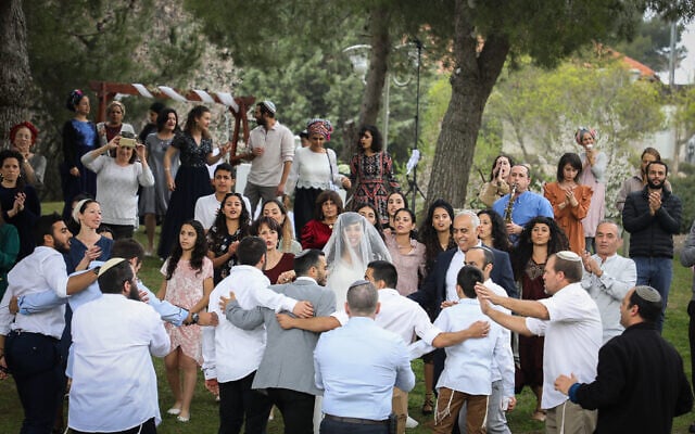 A couple celebrates their wedding at a public park in Efrat, March 15, 2020. (Gershon Elinson/Flash90) A couple celebrates their wedding at a public park in Efrat, March 15, 2020. (Gershon Elinson/Flash90)