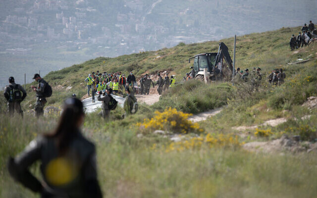 Illustrative: Israeli border police officers seen during the demolishing of six illegally built structures at the outpost of "Komi Ori", outside the Jewish settlement of Yitzhar, in the West Bank, April 22, 2020. (Sraya Diamant/Flash90) Illustrative: Israeli border police officers seen during the demolishing of six illegally built structures at the outpost of "Komi Ori", outside the Jewish settlement of Yitzhar, in the West Bank, April 22, 2020. (Sraya Diamant/Flash90)