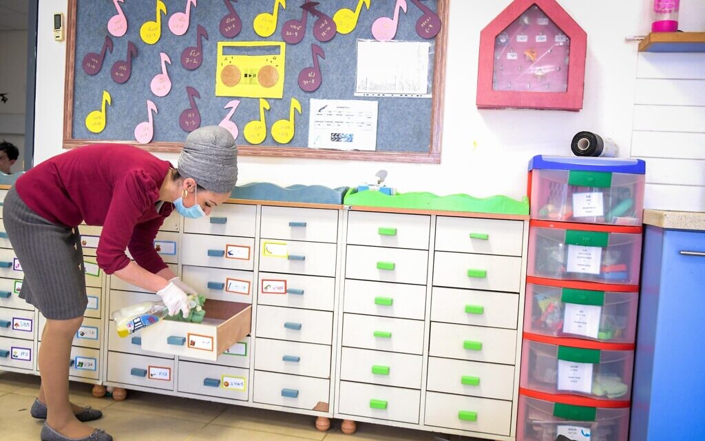 An illustrative photo of kindergarten teachers cleaning a classroom at Emunah daycare in the city of Modiin on May 7, 2020 (Courtesy Yossi Zeliger/Flash90)