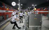 Train station staff and workers are seen receiving training instructions at Yitzhak Navon train station in Jerusalem, before a possible reopening order from the government on May 14, 2020. (Olivier Fitoussi/Flash90)