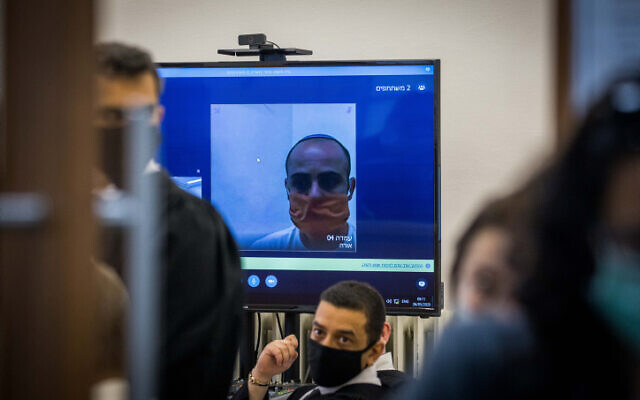 Eliran Malul, charged with stabbing his wife Michal Sela to death at their home in Ramat Motza, seen via a video link during a hearing at the Jerusalem District Court on May 26, 2020. (Yonatan Sindel/Flash90) Eliran Malul, charged with stabbing his wife Michal Sela to death at their home in Ramat Motza, seen via a video link during a hearing at the Jerusalem District Court on May 26, 2020. (Yonatan Sindel/Flash90)