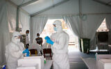 Magen David Adom medical workers test residents of south Tel Aviv for the coronavirus on June 2, 2020. (Miriam Alster/Flash90)