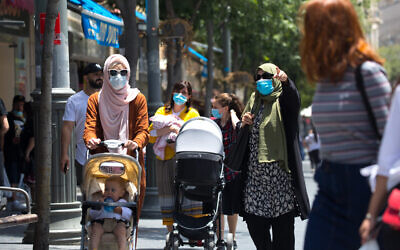 Israelis wearing face masks for fear of coronavirus walk in Jerusalem's city center after the government eased some lockdown measures that it had imposed in order to stop the spread of the coronavirus, on June 02, 2020. (Olivier Fitoussi/Flash90)