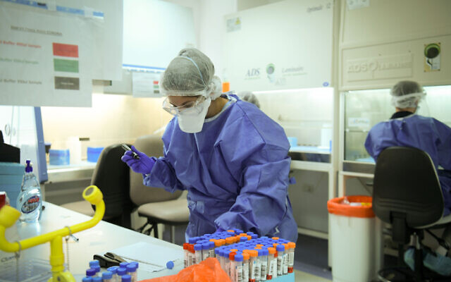 Technicians carry out a diagnostic test for coronavirus in a lab in Tel Aviv, on June 9, 2020 (Yossi Zeliger/Flash90) Technicians carry out a diagnostic test for coronavirus in a lab in Tel Aviv, on June 9, 2020 (Yossi Zeliger/Flash90)