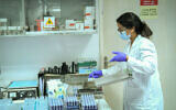 Technicians carry out a diagnostic test for coronavirus in a lab at Clalit Health Services branch in Tel Aviv, on June 9, 2020. (Yossi Zeliger/Flash90)