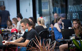 Israelis at a cafe in Tel Aviv on June 16, 2020. (Miriam Alster/Flash90)