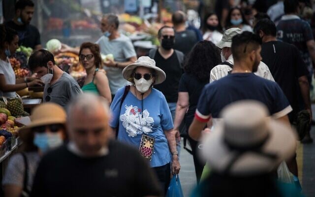 People shop for food at the Mahane Yehuda Market in Jerusalem on June 17, 2020. (Yonatan Sindel/Flash90)