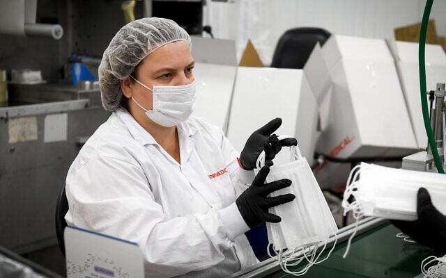 A Sion Medical workers makes protective masks at the company's factory in the southern city of Sderot on June 17, 2020. (Yossi Zeliger/Flash90) A Sion Medical workers makes protective masks at the company's factory in the southern city of Sderot on June 17, 2020. (Yossi Zeliger/Flash90)