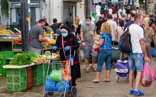 People shop at the market in Ramle on June 19, 2020 (Yossi Aloni/Flash90) People shop at the market in Ramle on June 19, 2020 (Yossi Aloni/Flash90)