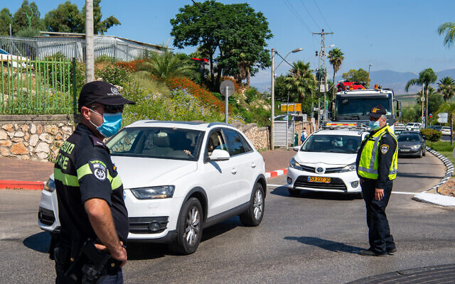 Illustrative: Police officers at the entrance to a neighborhood in Tiberias on June 24, 2020. (Basel Awidat/Flash90) Illustrative: Police officers at the entrance to a neighborhood in Tiberias on June 24, 2020. (Basel Awidat/Flash90)